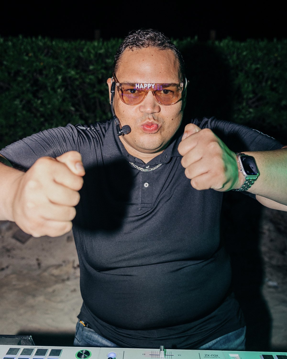Ruuben giving two thumbs up while wearing his headset at the DJ booth