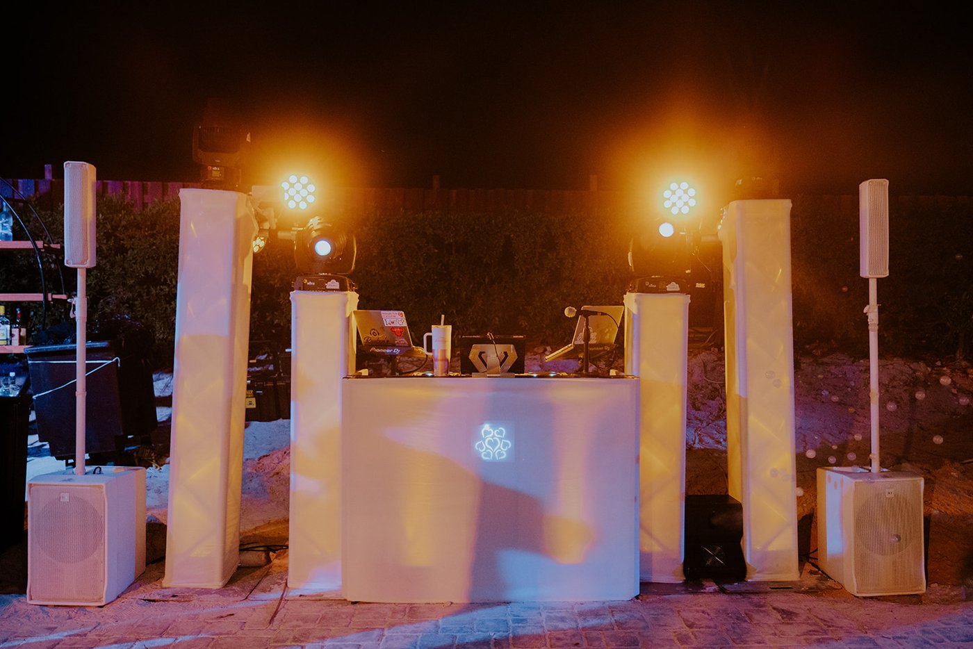 White DJ booth with warm and colored lighting